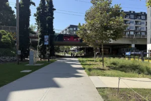 Walkers and cyclists on a sunny weekend on the Atlanta BeltLine Eastside Trail with murals along the path