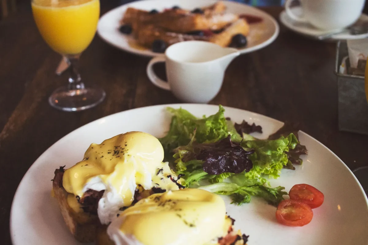 Weekend brunch table with eggs, pancakes and coffee at one of the best brunch spots in four U.S. cities