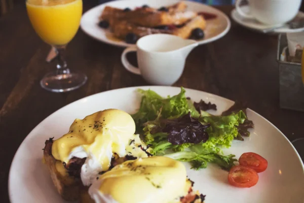 Weekend brunch table with eggs, pancakes and coffee at one of the best brunch spots in four U.S. cities