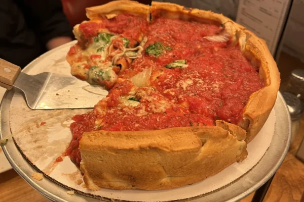 A deep dish pie next to a square-cut thin crust, comparing Chicago deep dish vs tavern-style pizza
