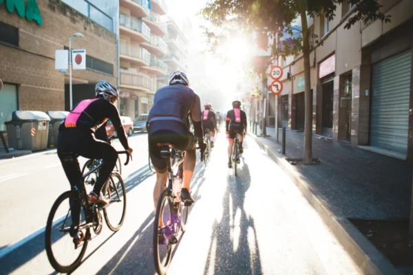 People walking and cycling along an urban greenway, an example of city living trends 2026 is shaping in neighborhoods