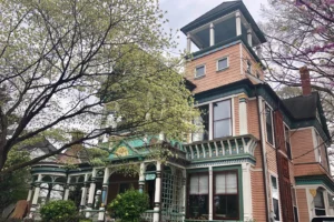 Victorian home on a tree-lined street, illustrating the Inman Park vs Old Fourth Ward neighborhood comparison in Atlanta
